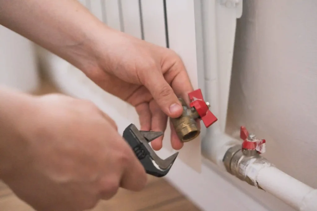 Someone trying to change the ball valve to a pip.